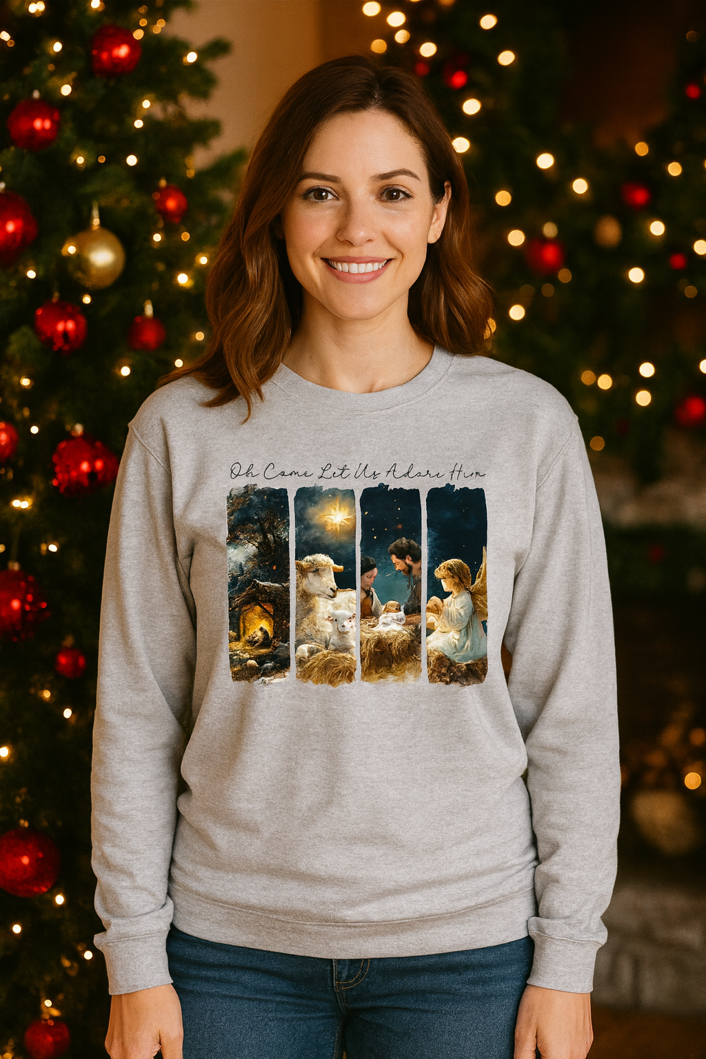 Woman wearing a gray sweatshirt with a Christmas-themed design in front of decorated trees.